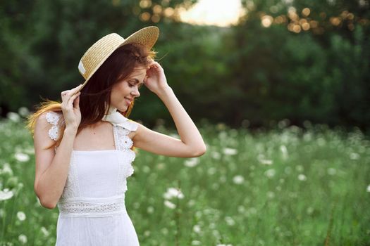 Woman with hat in a field of flowers nature freedom. High quality photo