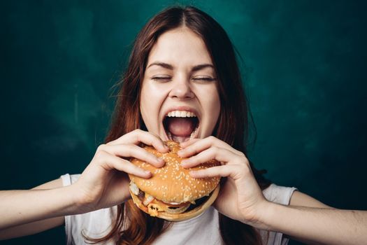 cheerful woman eating hamburger snack close-up lifestyle. High quality photo