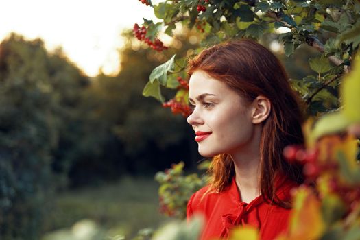 woman in red dress green leaves nature freedom summer. High quality photo