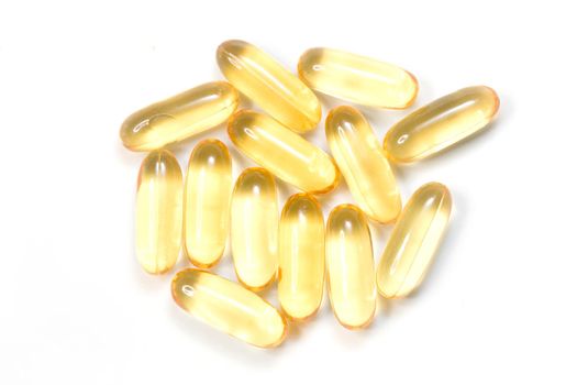 Close up golden color oil supplements in soft gel capsule, healthy product concept