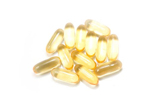 Close up golden color oil supplements in soft gel capsule, healthy product concept