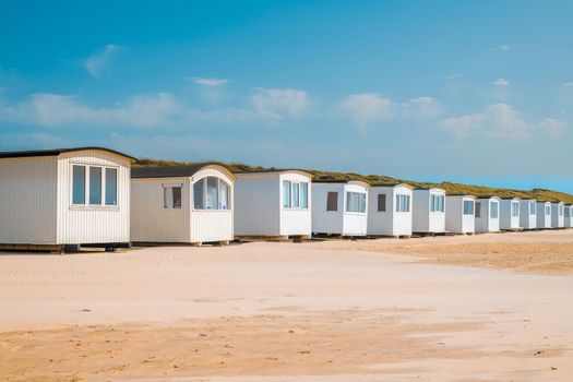 Little Muizenberg beach huts; beach huts on the sand with blue sky