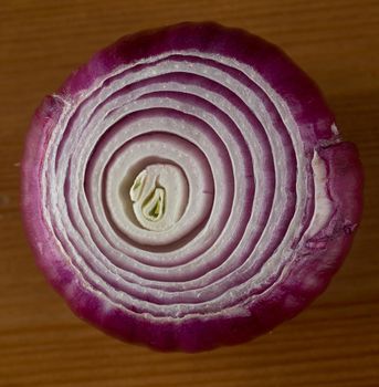 Red onion on wooden table