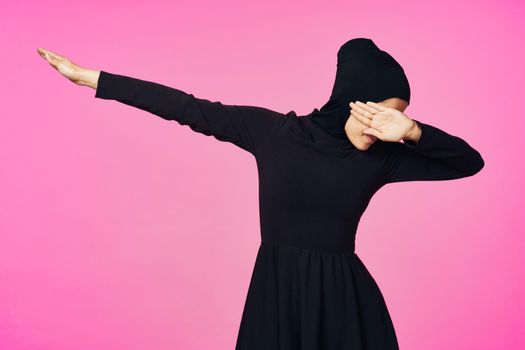 muslim woman in black hijab posing hand gesture model. High quality photo