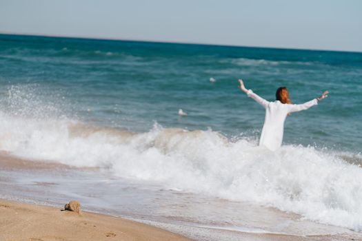 Woman in white dress near the ocean walk fresh air landscape. High quality photo