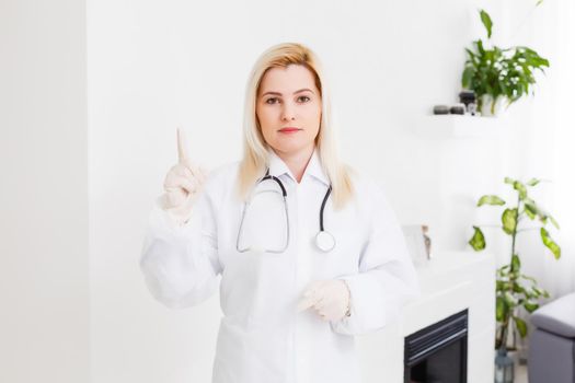 Portrait of a beautiful happy female doctor standing in the hospital