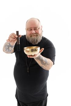 Funn caucasian bearded tattoed man is posing on white background