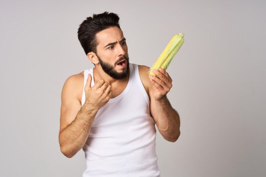 a man in a white t-shirt vegetables food diet strength snack studio lifestyle. High quality photo