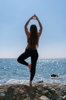 Group of young womans fitness instructor in Sportswear Leggings and Tops, stretching in the gym before pilates, on a yoga mat near the large window on a sunny day, female fitness yoga routine concept.