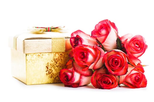 Golden gift box and bouquet of roses isolated on white