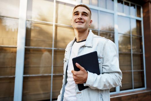 Portrait of handsome young casual man walking on the city street