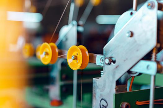 Cable production. Close up of a cable reel, manufacturing zone