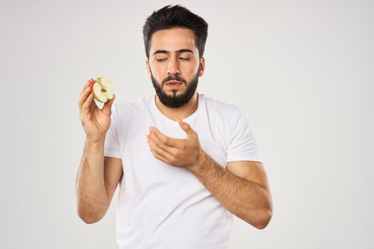 emotional bearded man with apple in his hands fruit snack. High quality photo