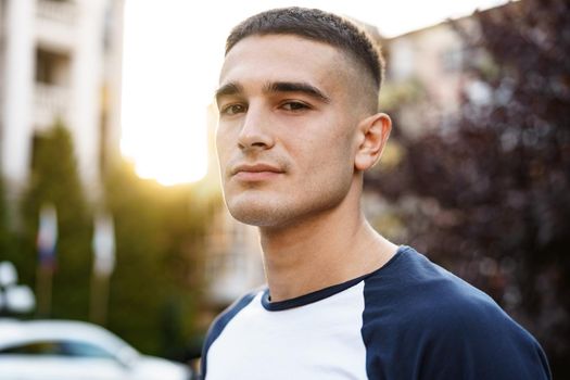 Portrait of handsome young casual man walking on the city street