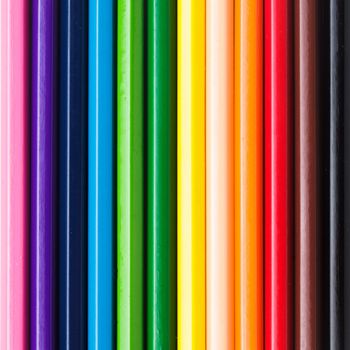 Rainbow color pencils in a row as a background