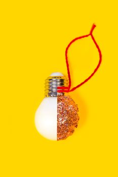 Reuse concept. New year or Christmas DIY decoration made from LED lamps and glitter