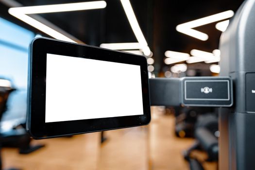 Close up of white screen on gym apparatus in a luxury gym, copy space