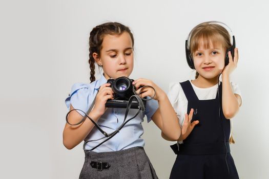 Two curious friendly schoolgirls watching photos at break