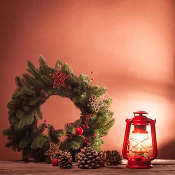 Cerosene lamp and Christmas wreath, decorations for holiday