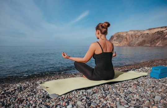 Group of young womans fitness instructor in Sportswear Leggings and Tops, stretching in the gym before pilates, on a yoga mat near the large window on a sunny day, female fitness yoga routine concept.