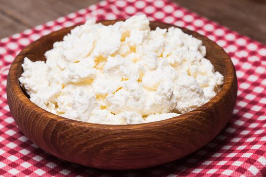 cottage cheese or curd in a wooden bowl