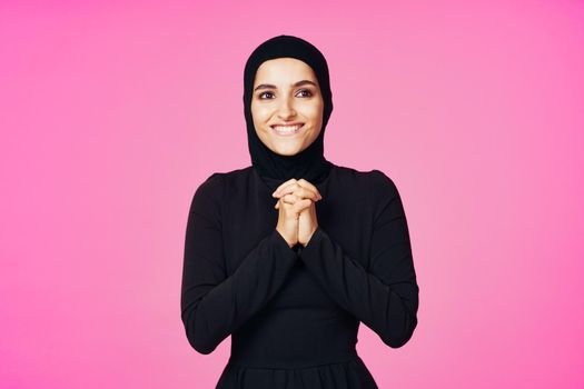 muslim woman in black hijab posing hand gesture model. High quality photo