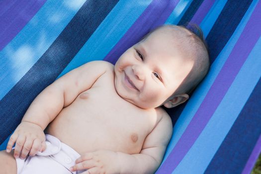 Baby in a hammock enjooys and relaxing