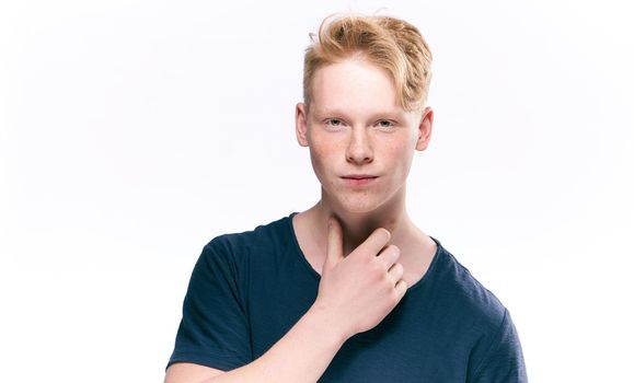 Redhead guy posing freckles close-up studio lifestyle. High quality photo