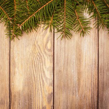 Christmas border evergreen on the wooden background