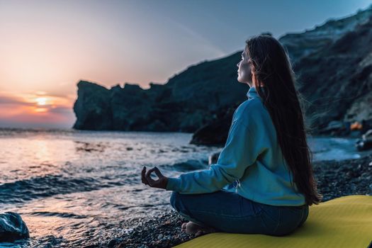 woman traveler drinks coffee with a view of the mountain landscape. A young tourist woman drinks a hot drink from a cup and enjoys the scenery in the mountains. Trekking concept