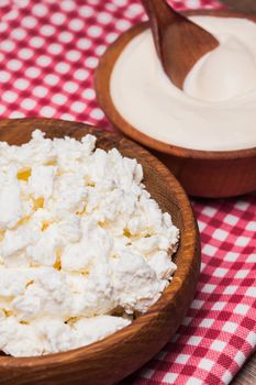 cottage cheese or curd in a wooden bowl