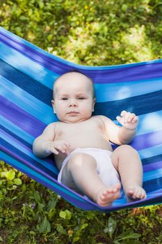 Baby in a hammock enjooys and relaxing