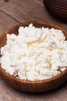 cottage cheese or curd in a wooden bowl