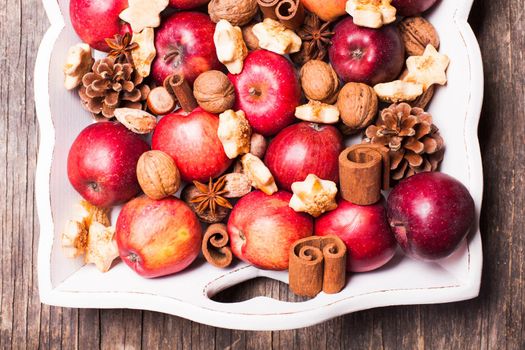 Apples, cones, nuts and cookies with spices. Aroma Christmas