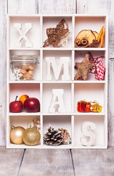Christmas decoration in a wooden box. Cozy holiday in home. Wood letters XMAS in shadow box memories
