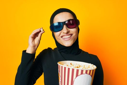 pretty woman in black hijab popcorn 3D glasses cinema studio lifestyle. High quality photo