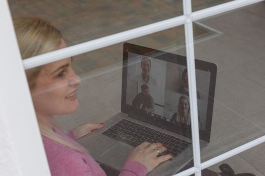 Woman Working From Home Having Group Videoconference On Laptop