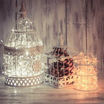 Christmas light decoration in a white bird cage.