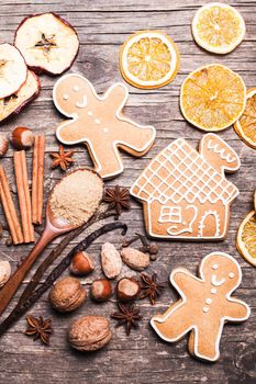 Gingerbread cookies on a wooden table with ingredients