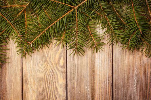 Christmas border evergreen on the wooden background