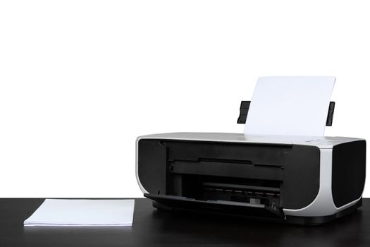 Laser home printer on table against white background, close up