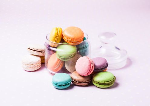 Colorful macaroons - french dessert in a glass jar