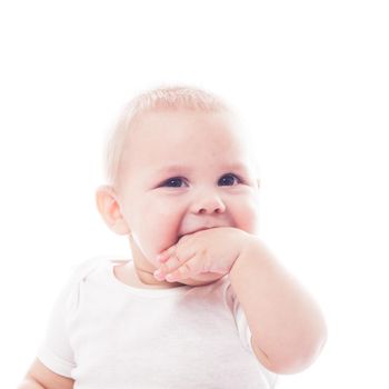 Adorable baby with finger in the mouth