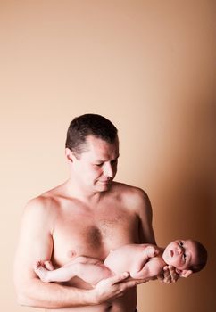 Newborn baby girl in the fathers' hands