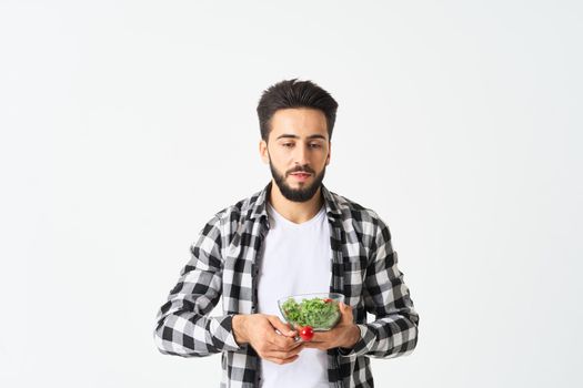 cheerful man in plaid shirt plate with salad healthy food. High quality photo