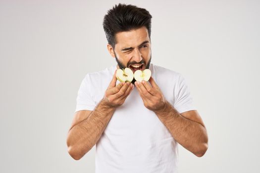 emotional bearded man with apple in his hands fruit snack. High quality photo