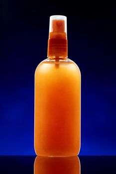 Glass bottle with cosmetic oil on dark background close up