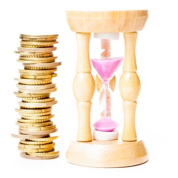 Time is money concept - coins and sandglass