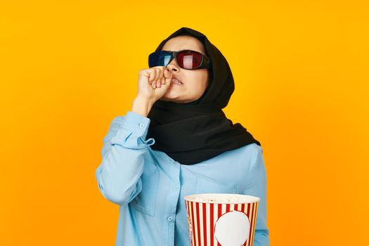 Muslim entertainment going to the cinema popcorn yellow background. High quality photo