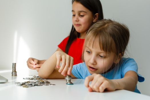 Two kids counting coins together